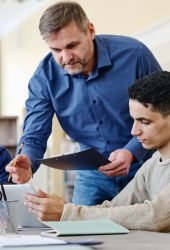 teacher-helping-to-do-task-2023-11-27-05-34-27-utc